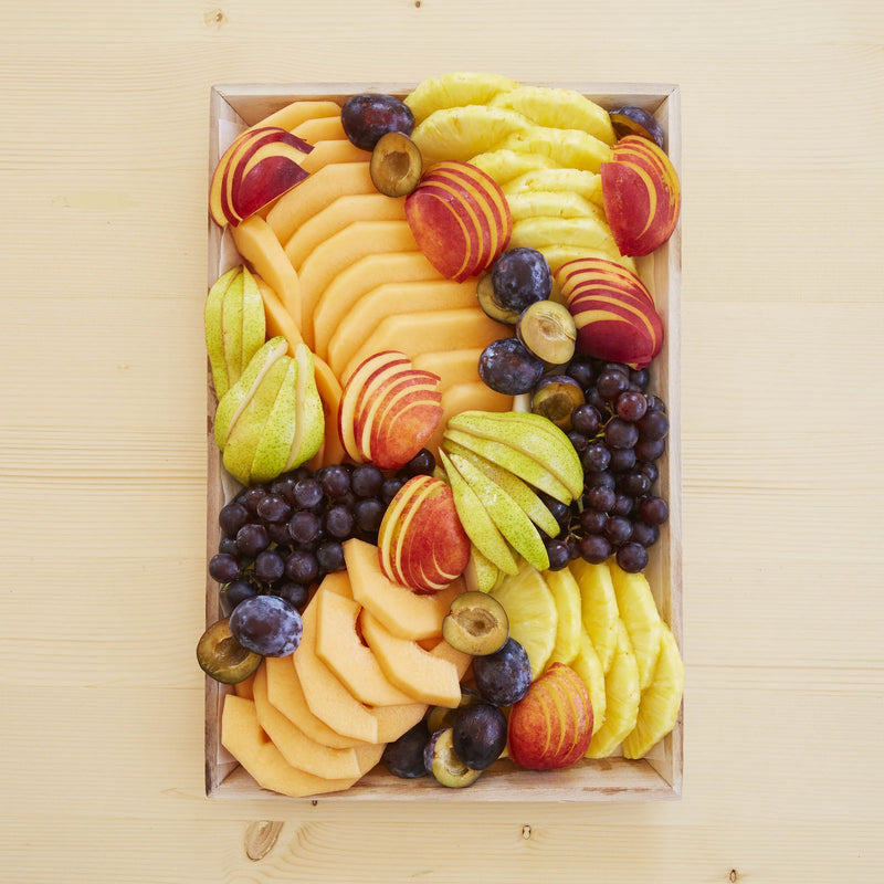 A platter of assorted late summer fruits.