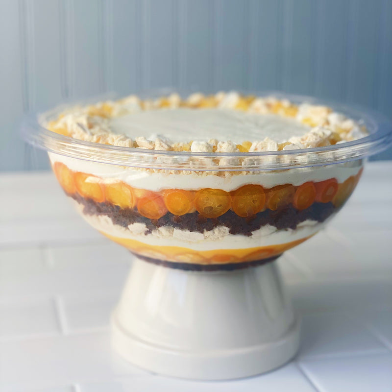 A layered trifle dessert in a glass bowl.