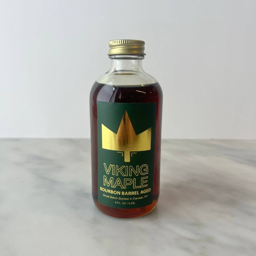 Bottle of Viking Maple syrup on a table.