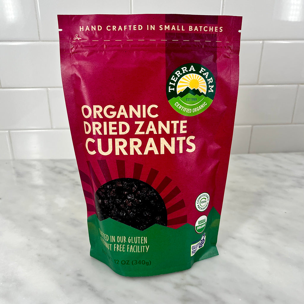 Packaging of organic dried Zante currants on a kitchen counter.