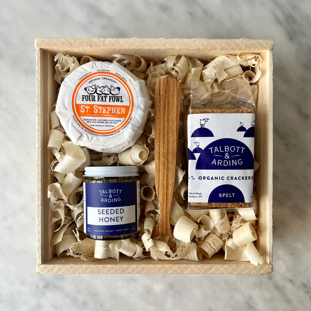 A gourmet cheese and snacks gift box.