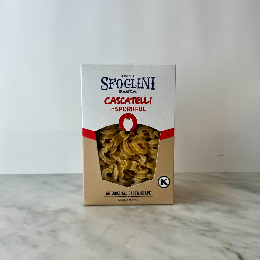 A box of Sfoglini Cascatelli pasta on a countertop.