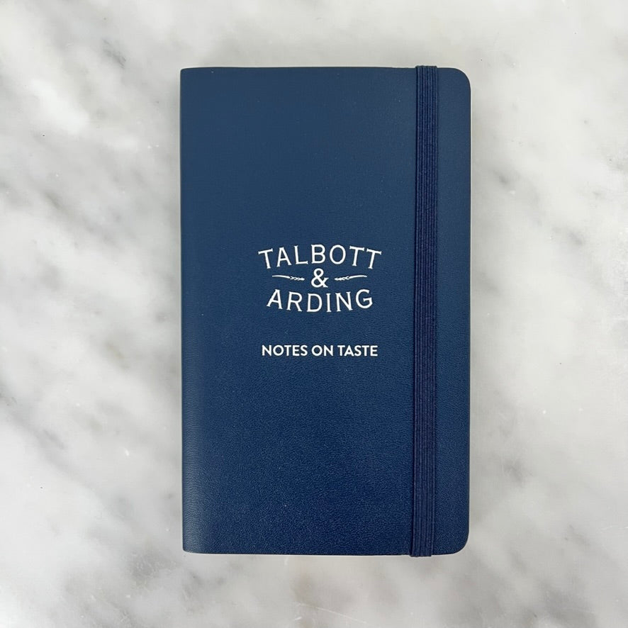 Closed blue notebook with text on cover.