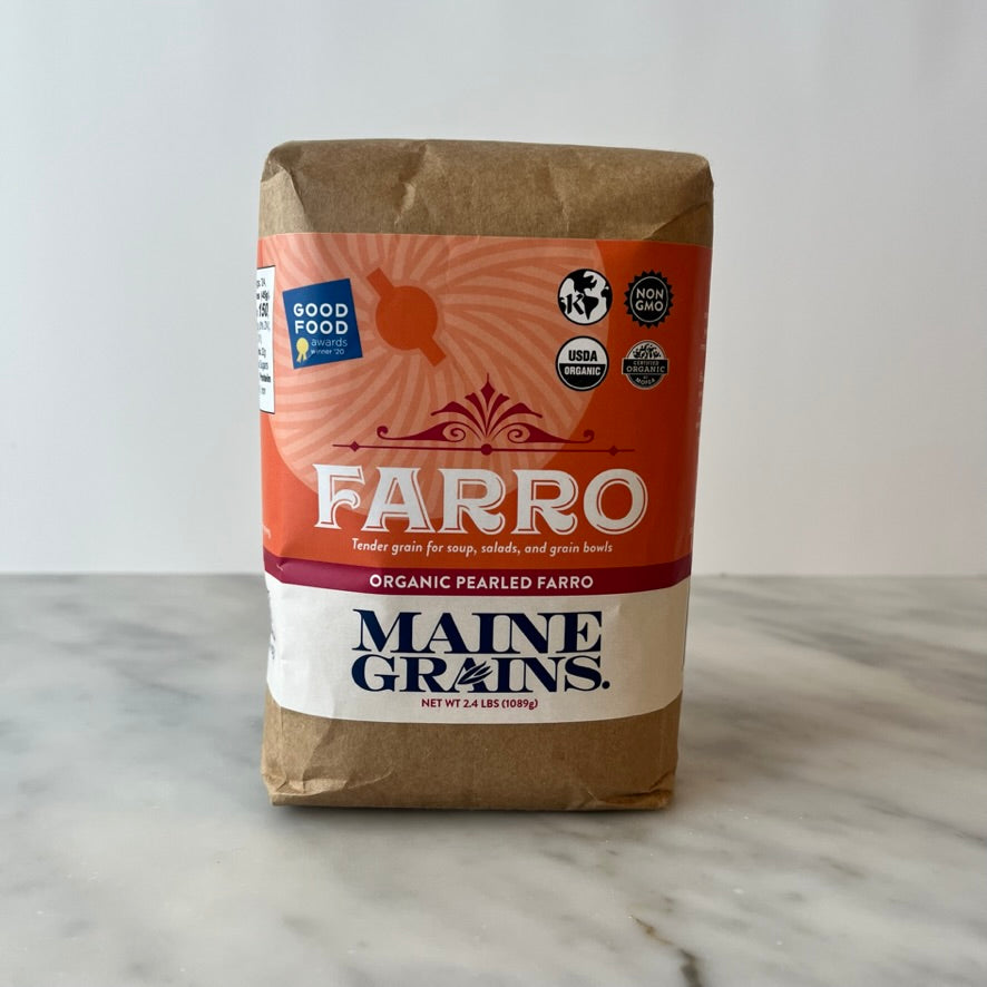 Package of organic pearled farro on a countertop.