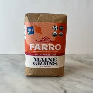 Package of organic pearled farro on a countertop.