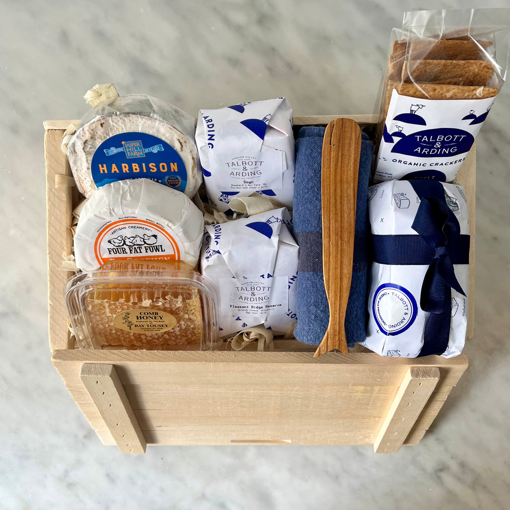 Gourmet food items in a wooden gift box.
