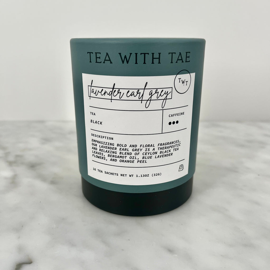 A candle with "Tea with Tae Lavender Earl Grey" label on a marble surface.