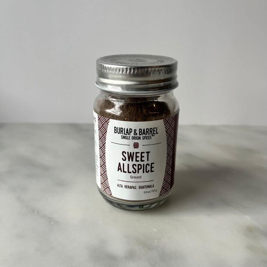 Jar of sweet allspice on a table.
