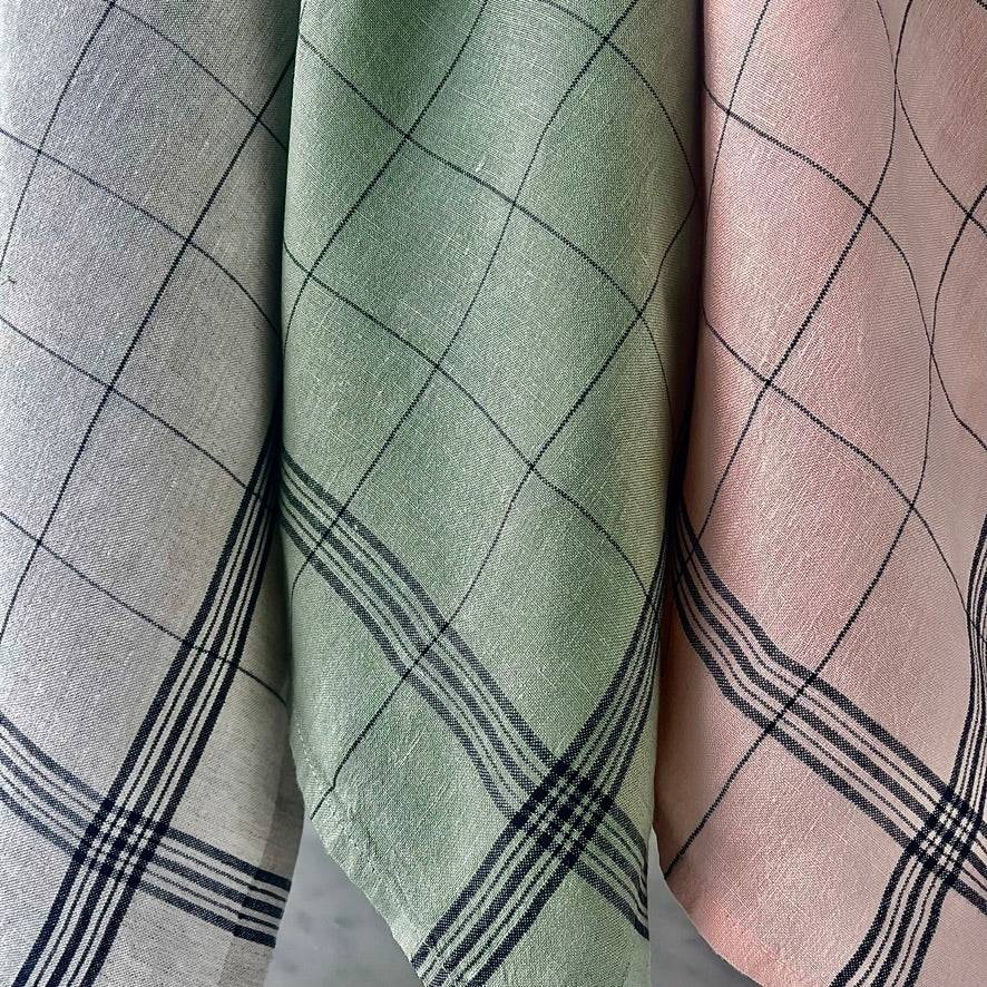 Three different colored fabrics with plaid patterns.