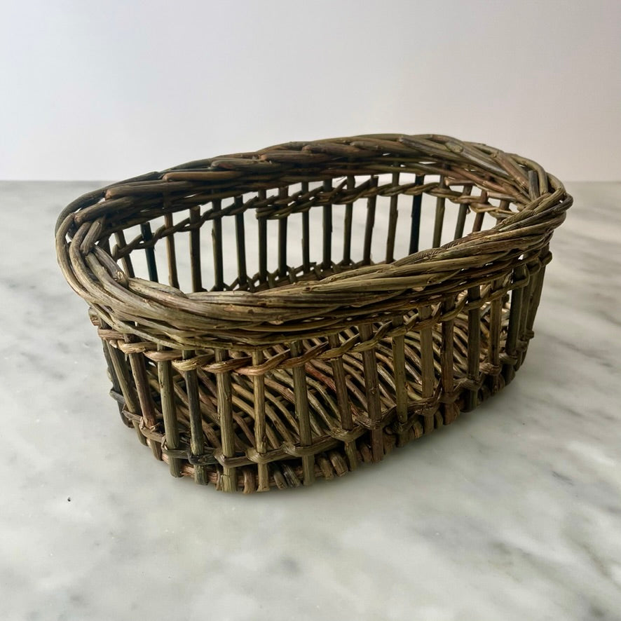 Woven wicker basket on a marble surface.