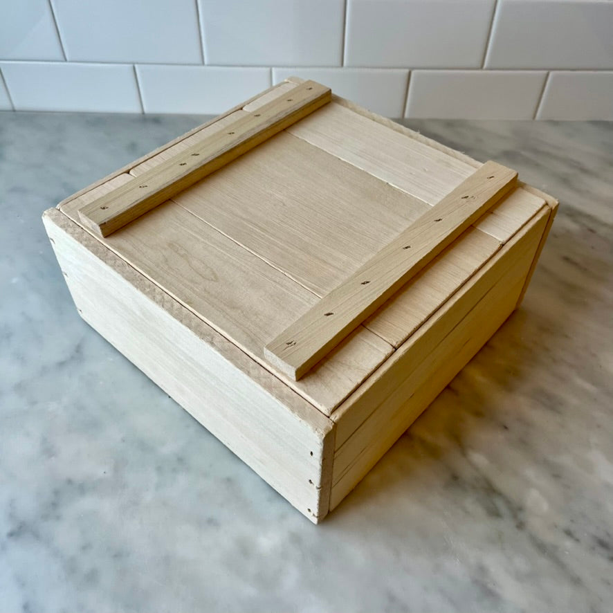 Wooden crate on a marble surface.
