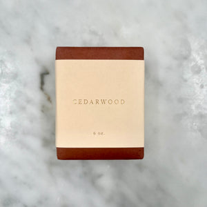 Cedarwood soap bar on marble surface.
