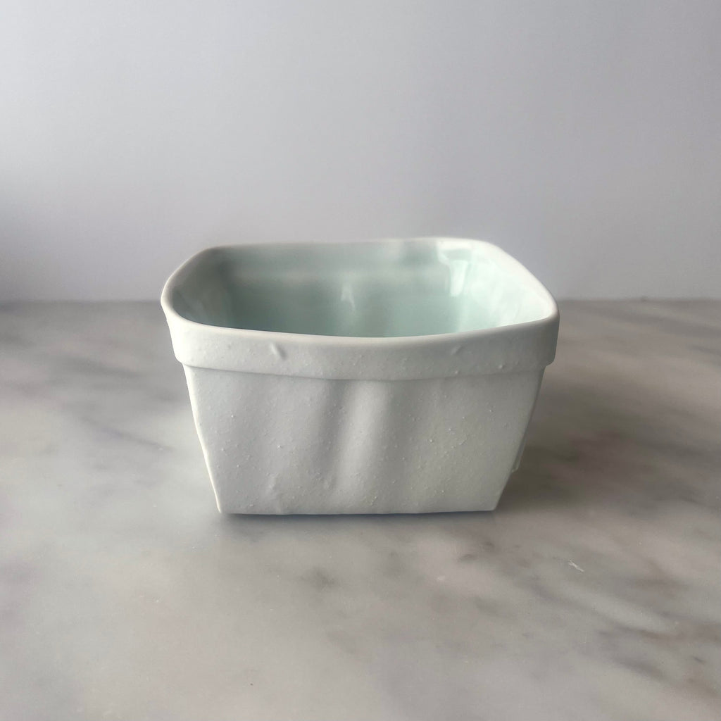 Ceramic planter on a marble surface.