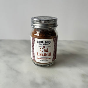 Jar of cinnamon on a table.