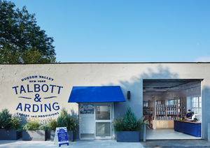 Storefront of "Talbott & Arding" with open entrance.