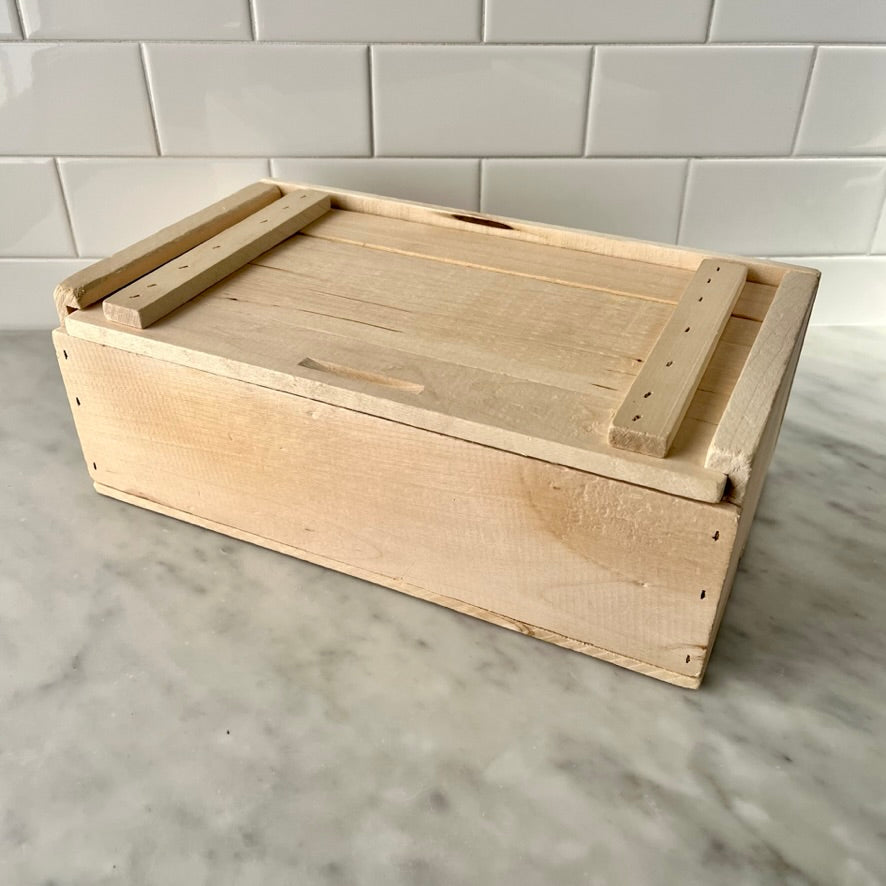 Wooden crate on a marble counter.