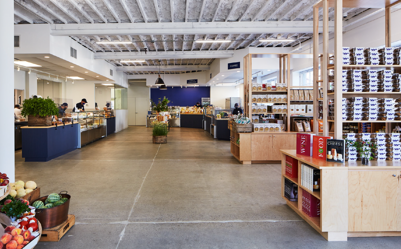 Modern grocery store interior with fresh produce and products on display.